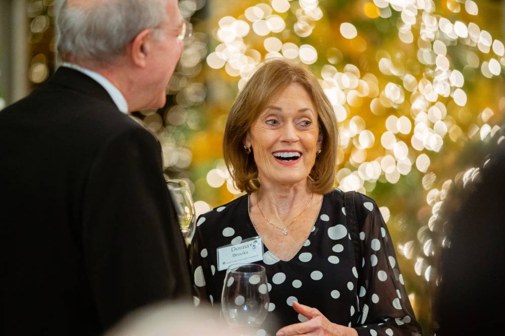 Donna Brooks talking with guests at the Foundation Holiday Reception